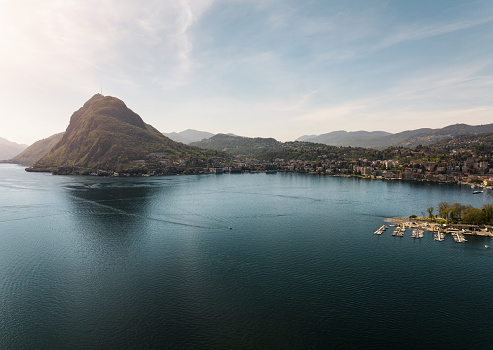 Aerial view of Beautiful Lugano Lake and Lugano City next to mount San Salvatore in Southern Switzerland, Ticino Canton.