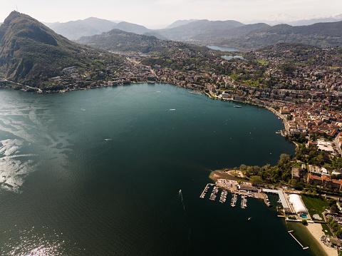 Aerial view of Beautiful Lugano Lake and Lugano City next to mount San Salvatore in Southern Switzerland, Ticino Canton.