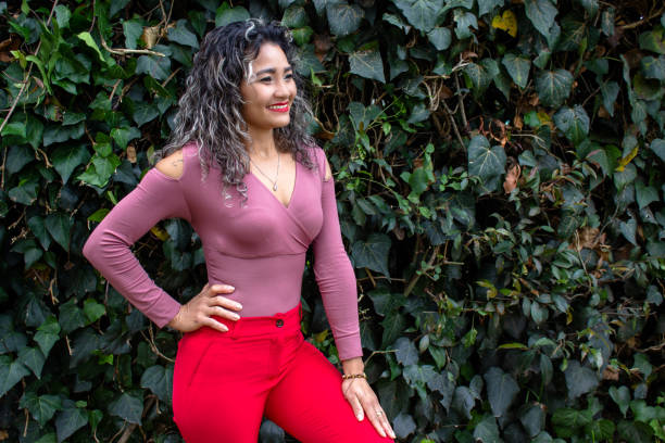 istock Beautiful young woman posing in a public park 2149050676