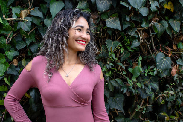 istock Beautiful young woman posing in a public park 2149050701