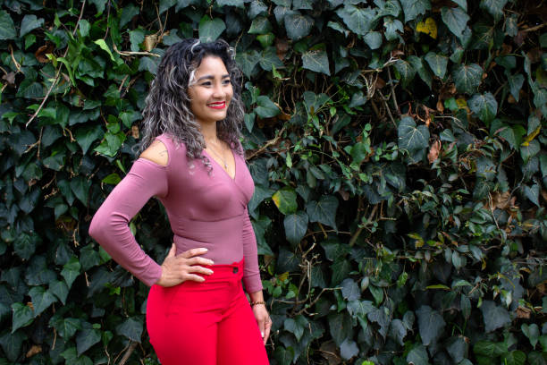 istock Beautiful young woman posing in a public park 2149050706