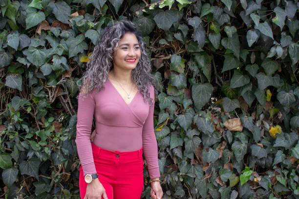 istock Beautiful young woman posing in a public park 2149050708
