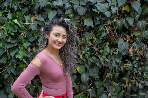 istock Beautiful young woman posing in a public park 2149050727