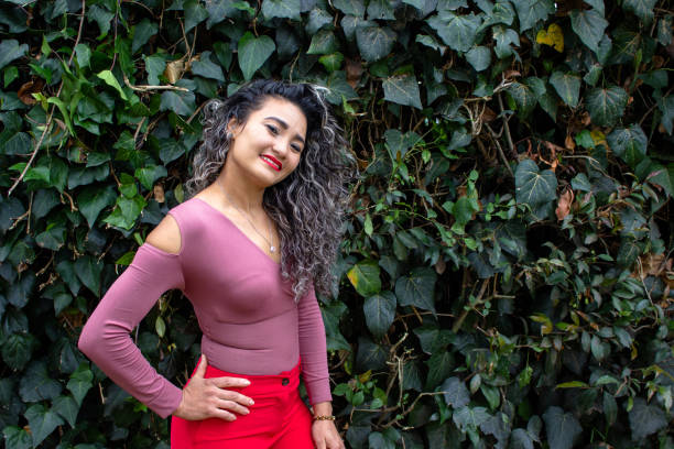 istock Beautiful young woman posing in a public park 2149050731