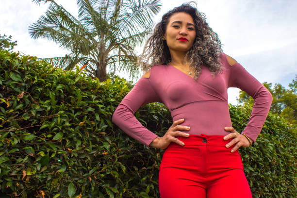 istock Beautiful young woman posing in a public park 2149050837