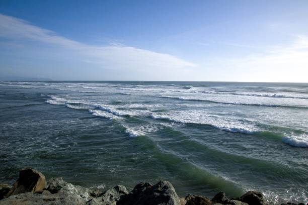 Wave on the ocean as taken from a breaker on a mostly clear day. Taken while hiking in Fort Stevens State Park, which contains a former military instillation and is a Lewis and Clark National Historic Site, located to the west of Astoria, OR between the Pacific Ocean and the Columbia River.