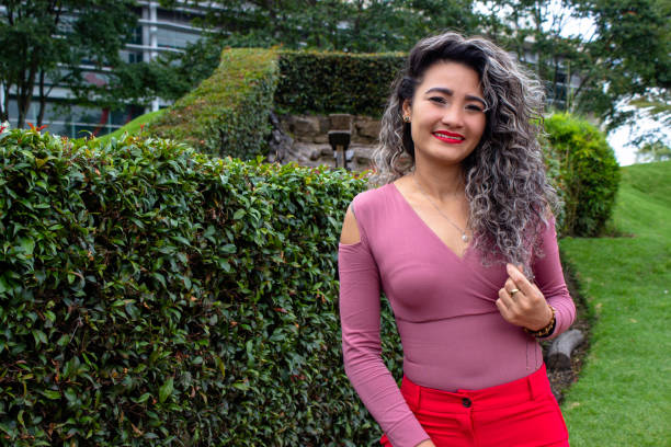 istock Beautiful young woman posing in a public park 2149050959