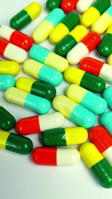 Vertical video, Colorful medicine capsules rotating close up