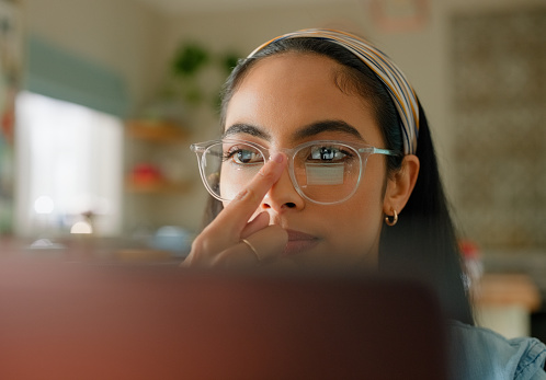 Woman, glasses and ready on laptop for online education, research and planning essay with e learning at home. Student or person for eye care, vision or getting started on assignment or school project