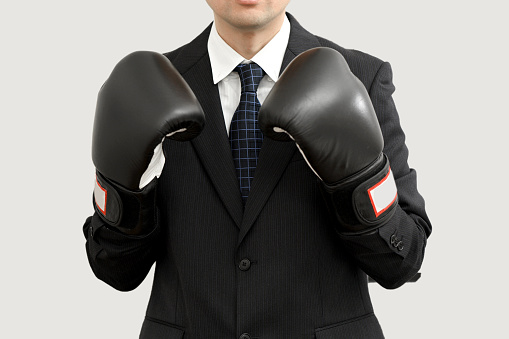 Businessman in a suit taking a fighting pose