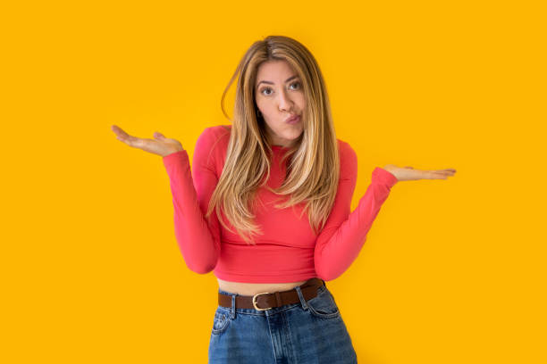 istock Image of a perplexed and surprised beautiful woman on a yellow background. 2149053693