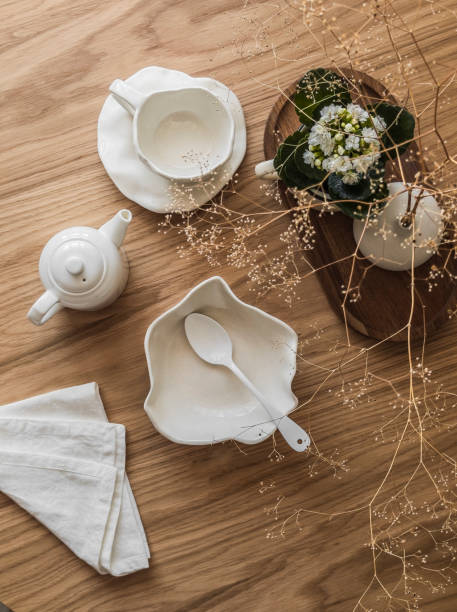 istock Aesthetic breakfast setting - ceramic tableware, tea pair, bowl, teapot, decor on a wooden table, top view 2149054759