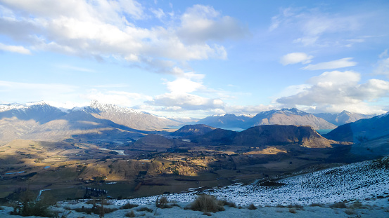 The dramatic scenery of New Zealand's South Island. Large mountains in the distance with pine forests and plains stretching out in every direction on a clear winters day