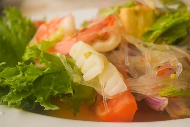 close up a spicy thai seafood glass noodle salad on a table, Thai food concept