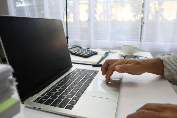 istock businessman hands searching for data on Notebook with analyzing charts at his workplace. 2149055291