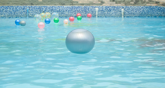 close up a big ball floating on a clear water in a pool