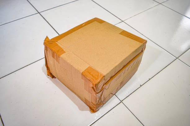 istock Cardboard boxes insulated with tape for sending packages lay on the floor 2149056759