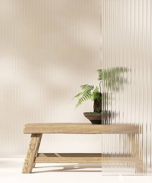 istock Tropical palm tree on wooden table counter and reeded glass partition in dappled sunlight on beige white wall 2149057370