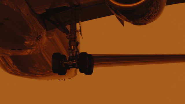 low angle view of air passenger taking off at sunset orange sky slow motion