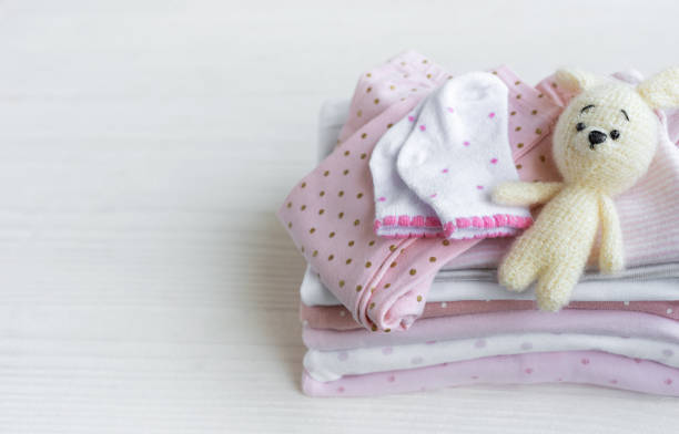 istock Stack of baby clothes, socks and knitted toy 2149057871
