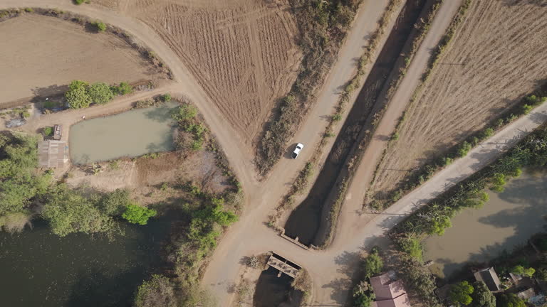 Drone footage aerial view scenic landscape of driving pickup truck deserted road in the rural place dry season
