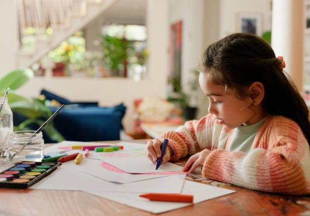 istock Girl, child and drawing with color in home for development, learning and creativity with paper at desk. Kid, sketch and crayon for skills, art and creativity with pattern to relax in family house 2149058670