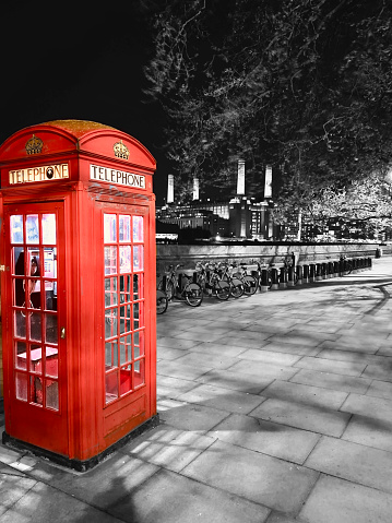 red phone box London U.K on Thames embankment with Battersea power station in background