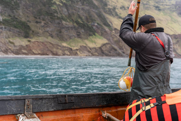 istock Fisherman using a hook to pick up a buoy 2149060937