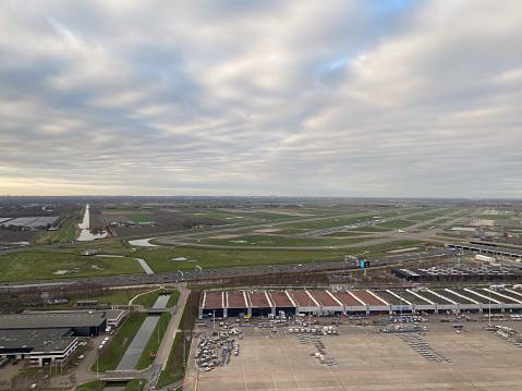 Aerial view of Schiphol airport terminal  in Holland from a jet plane window