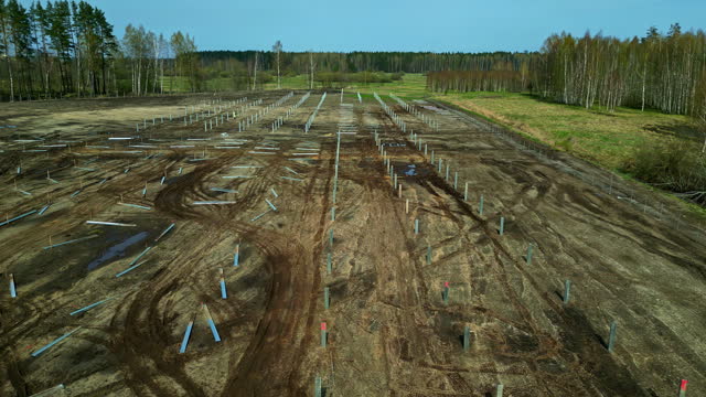 Aerial View Of A Working Solar Pile Driving Equipment In The Fields.