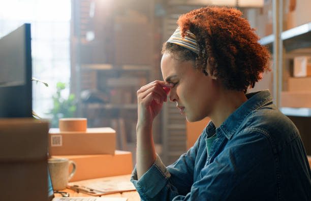 istock Headache, computer or woman with boxes for shipping mistake, inventory crisis or manufacturing. Stress, anxiety or tired logistics officer in factory for wholesale distribution, production or import 2149061297