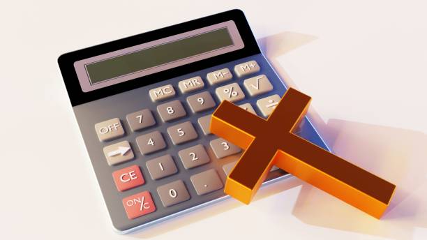 istock a calculator and gold cross on the white background 2149061733