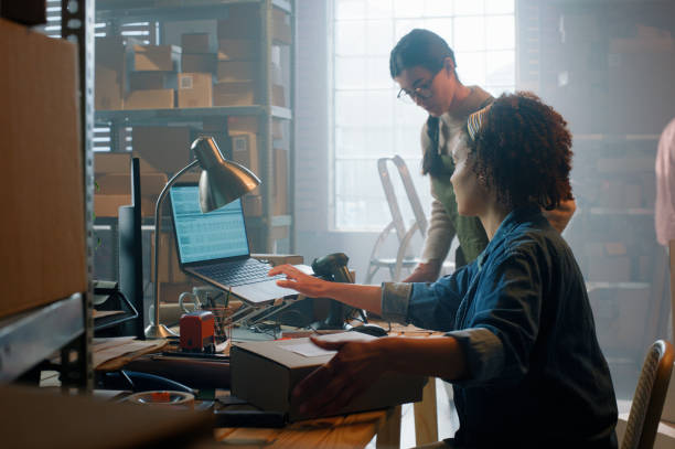 istock Ecommerce, small business and women in warehouse together with teamwork at creative startup for distribution. Boxes, online shop and partnership with laptop, sales and web store for dropshipping 2149061802