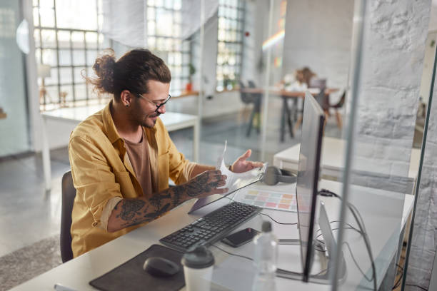 istock Young businessman working on reports at corporate office. 2149064611