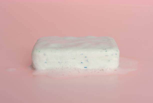 White Soap Bar, Body Care Cosmetic, Fruit Flavored Soapy Detergent, Solid Shampoo, Red Translucent Glycerin Soap on Pink Foamy Background