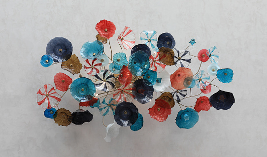 decorative colored artificial glass flowers on the wall