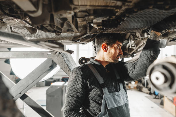istock Workman mechanic working under car in auto repair shop 2149069037