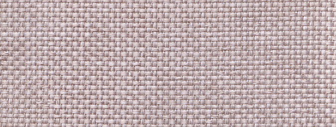 Texture of light gray color background from woven textile material with wicker pattern, macro. Structure of vintage ivory fabric cloth, narrow backdrop.