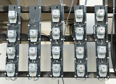 Rows of old watthour meters on panel.