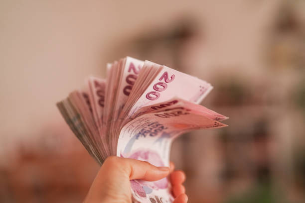 istock Turkish Money in human hands 2149071132