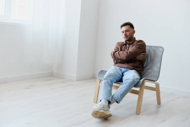 istock Sad frustrated suffering from bad relationship break up young man guy hugs himself looks aside have big mental problem psychological trauma after family conflict think about life's meaning. Copy space 2149071221