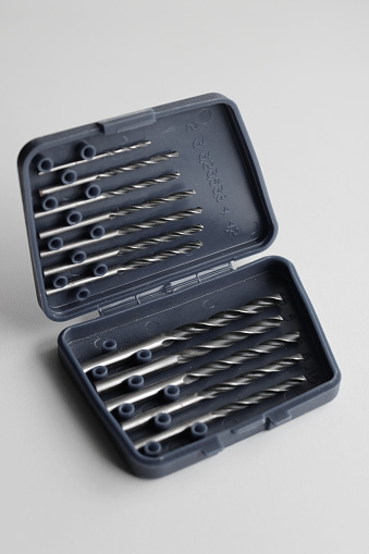 Opened lid of set box for drill bits storage studio isolated stock photo