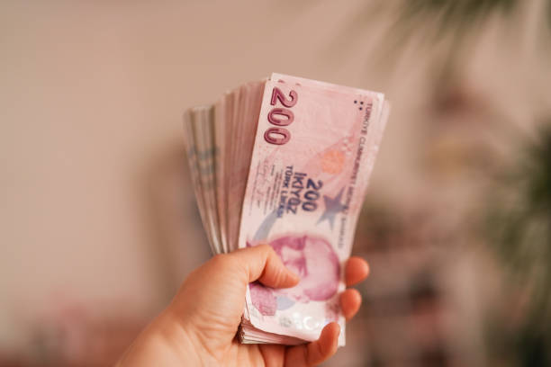 istock Turkish Money in human hands 2149071453