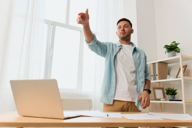 istock Cheerful happy self-confident handsome stylish young businessman talk with subordinates staying near office table. Copy space for ad. Remote Job, Technology And Career Profession Concept 2149072000