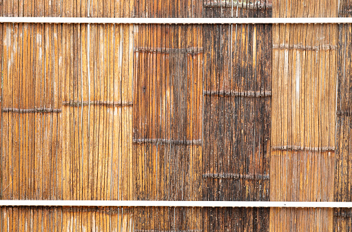 Wheathered bamboo wall built on white frame