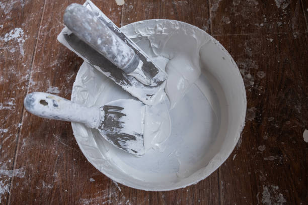 istock Applying decorative putty. White abstract texture of surface covered with putty 2149072302