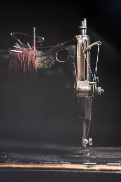 istock Old sewing machine stands on the table at home ready to work and sew. 2149072370
