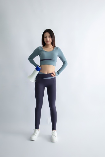 Asian woman in sportswear holding a megaphone