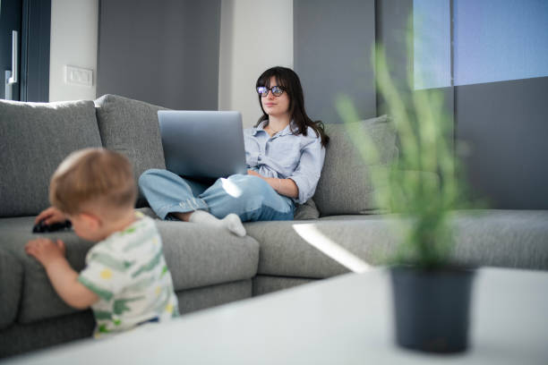 istock Busy mom keeping her work going and taking care of her son. 2149073225