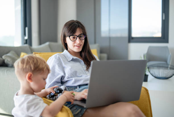 istock Multitasking woman working from home while taking care of her son. 2149073229